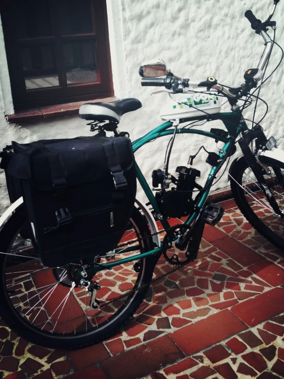 a bicycle sits in front of a wall and windows