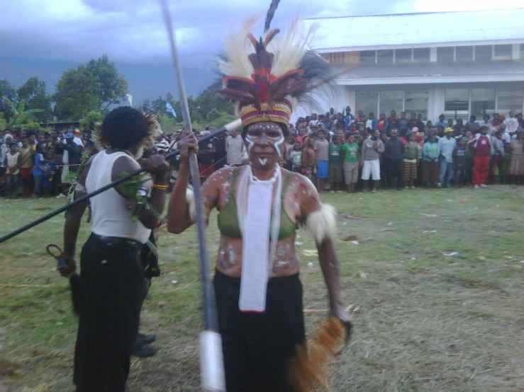 people on the field with a person with a feathered headdress