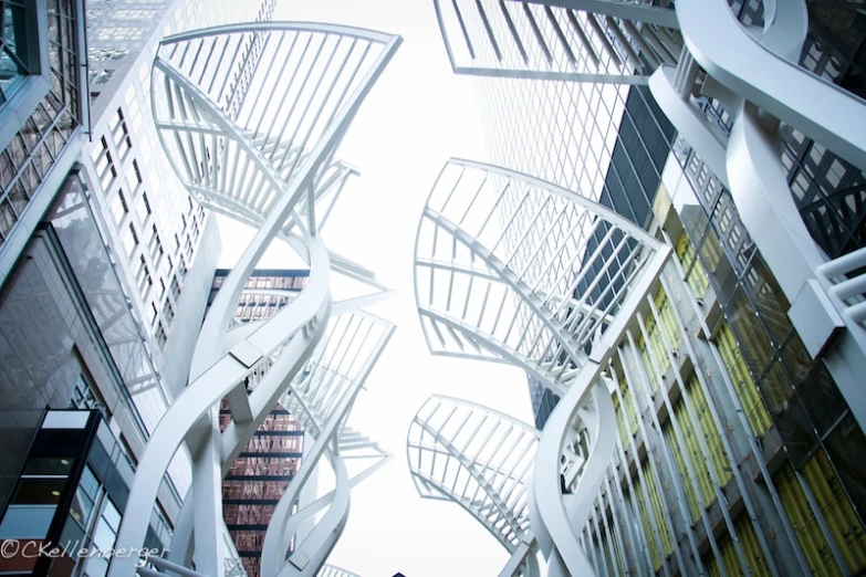 some very tall white metal sculptures and buildings