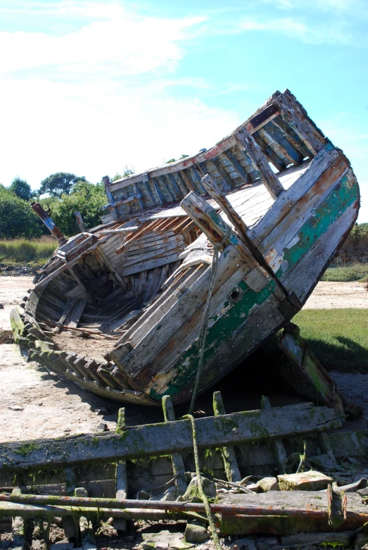 an old boat has been sitting on land