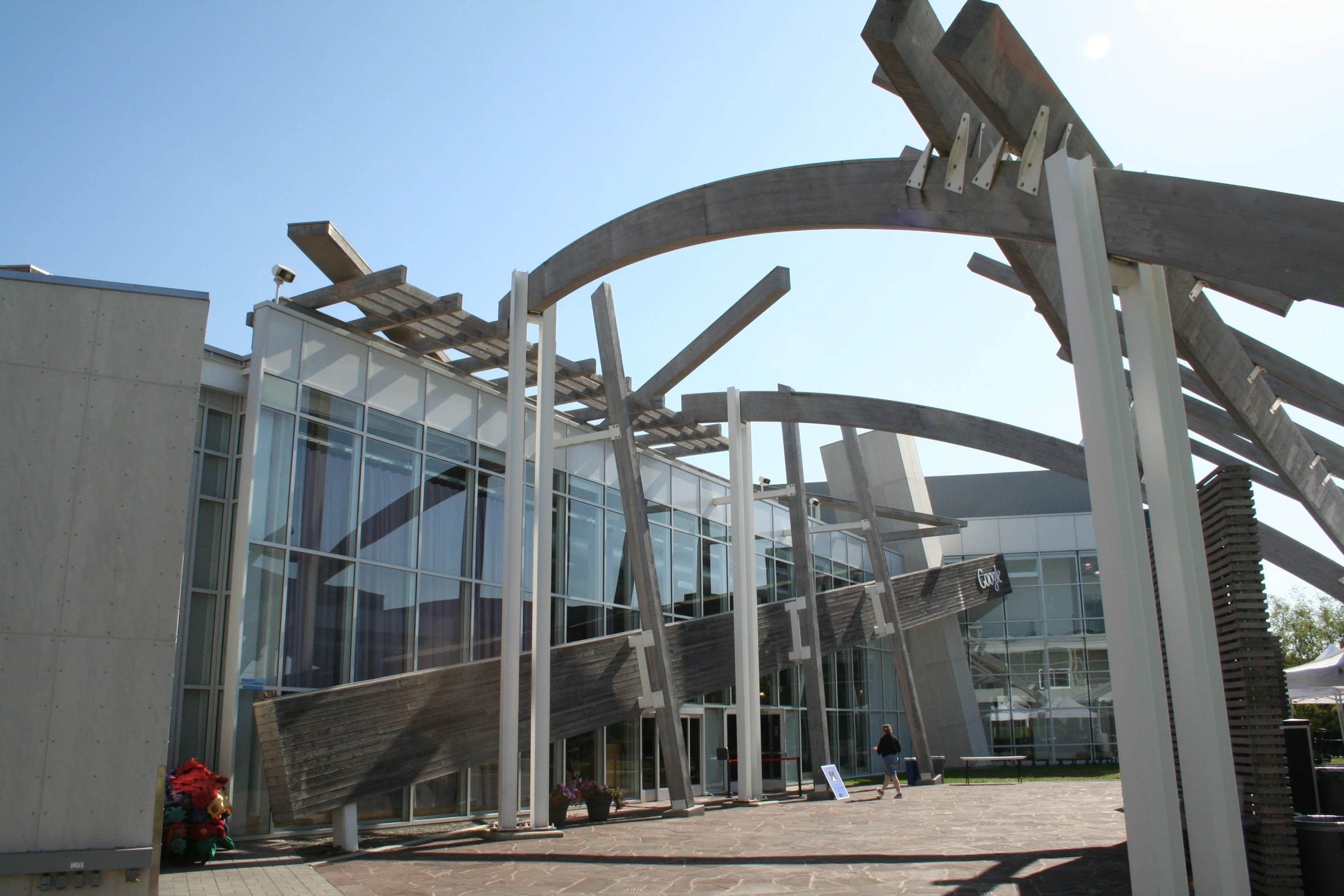 large sculpture in front of a large glass building