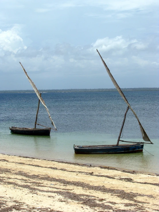 a couple of sailboats floating in a body of water