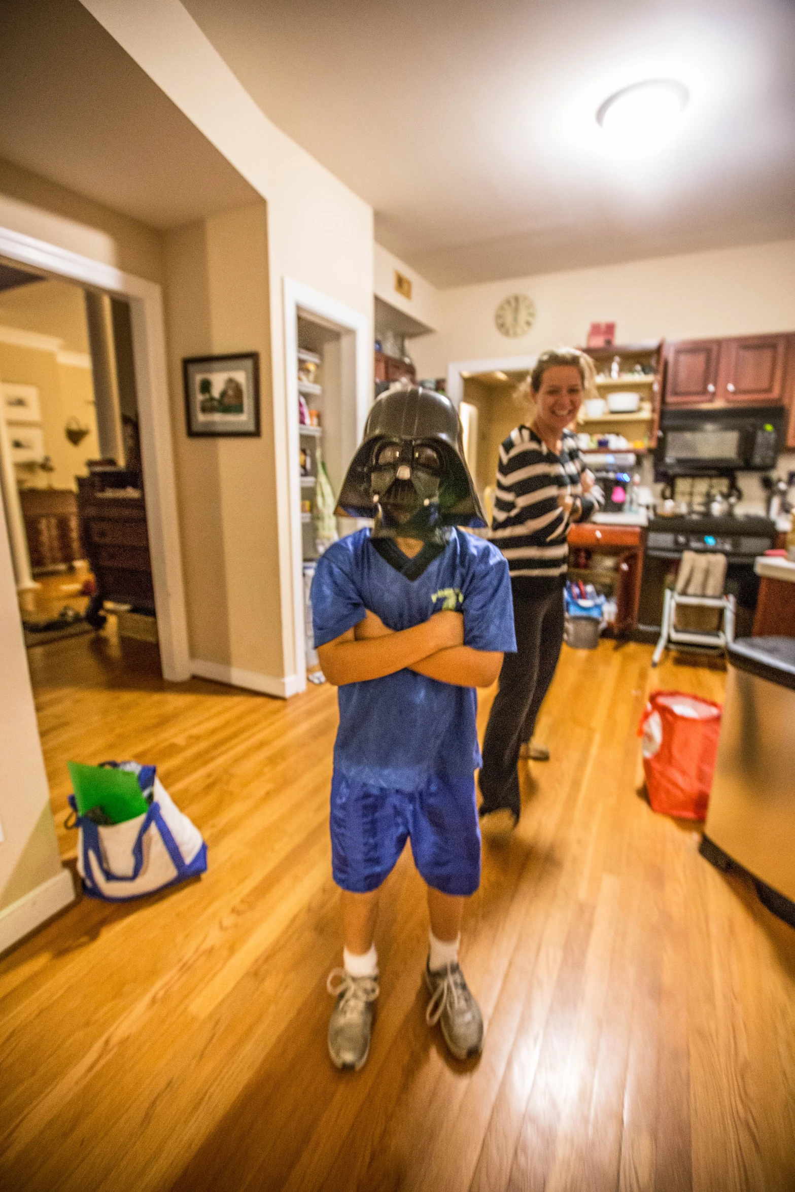 a boy holds his father while the girl walks down the hallway