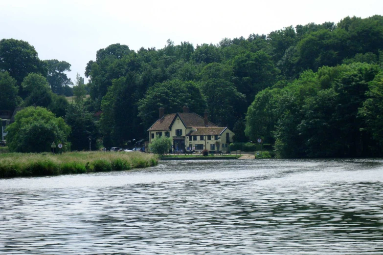 a body of water with houses in the background