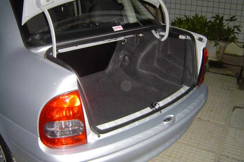 a car with its trunk open and its seat folded up