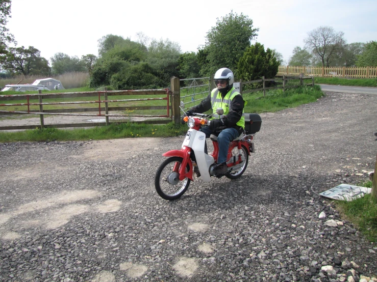 a man on a motor bike in front of an open field