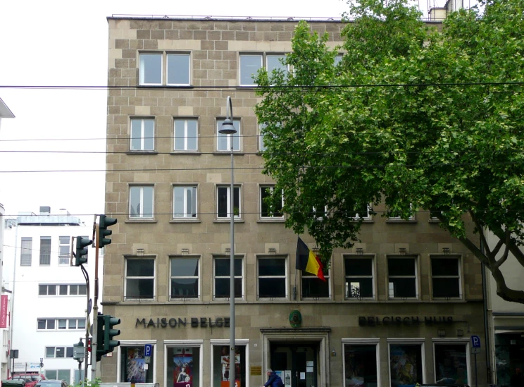 a tall building with windows sitting next to some trees