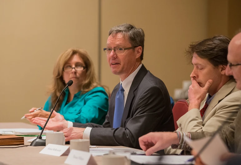 two people sit at a table during a meeting