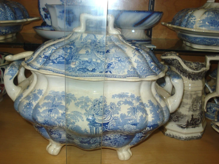 blue and white dishes on display in a store