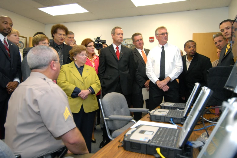 several men and women in a large office