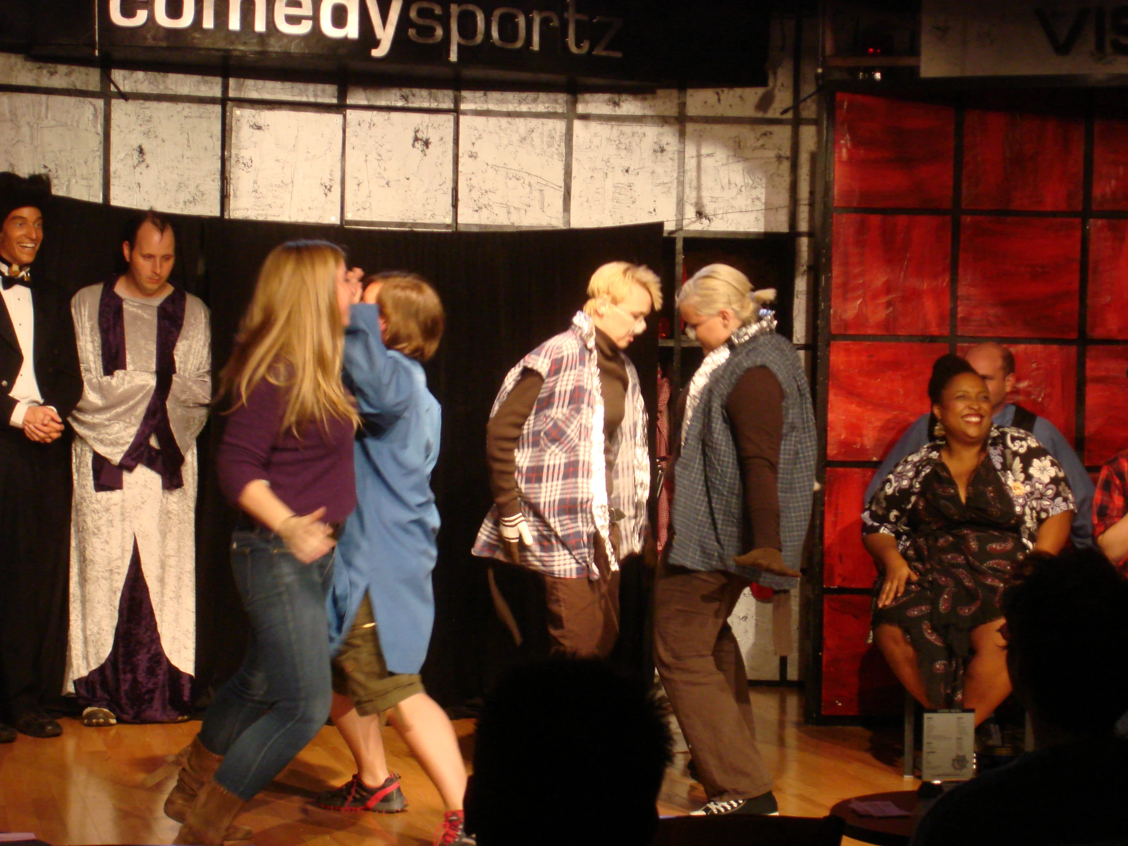 a group of people standing around on stage