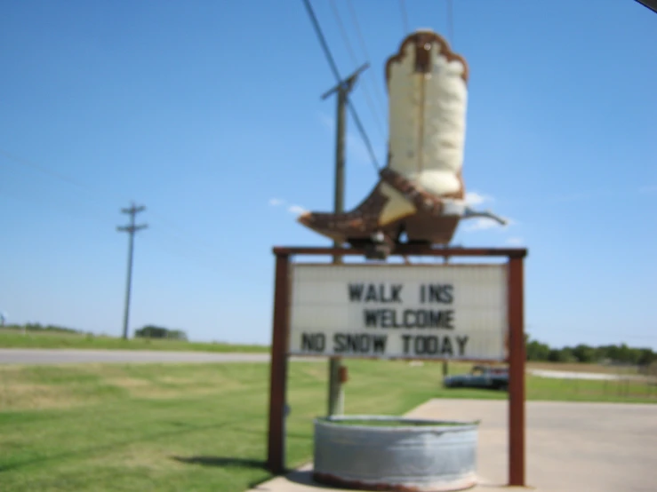 the sign for a boots shop in an empty lot