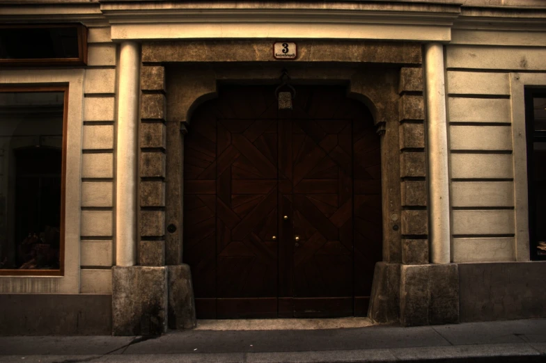 a big wooden door to a building in the evening