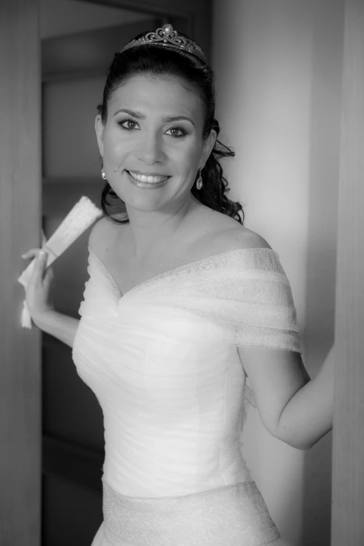 a woman in a white wedding dress holding a towel