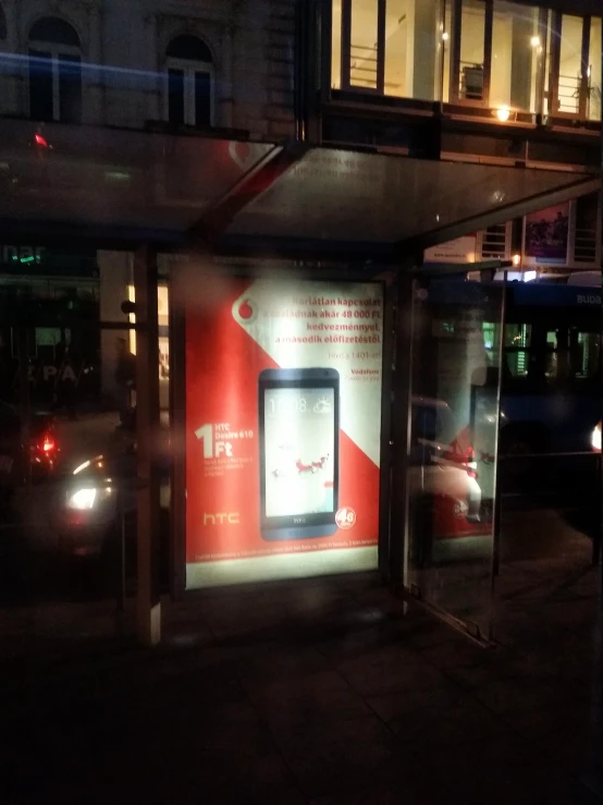 a bus stop that is parked next to a building