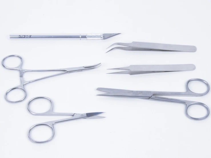 a set of five scissors with one side missing