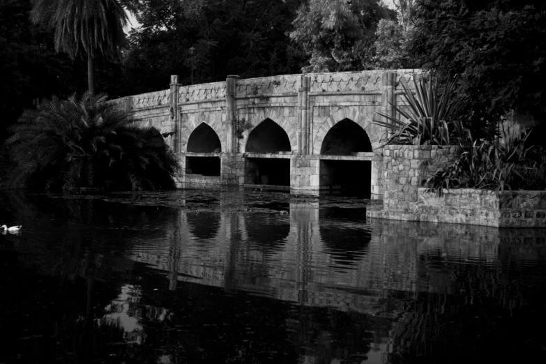 black and white pograph of bridge over a river
