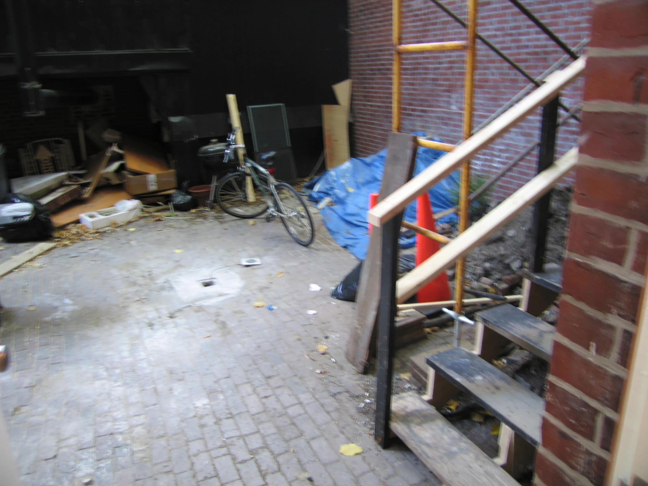 two bikes sitting on top of stairs near trash