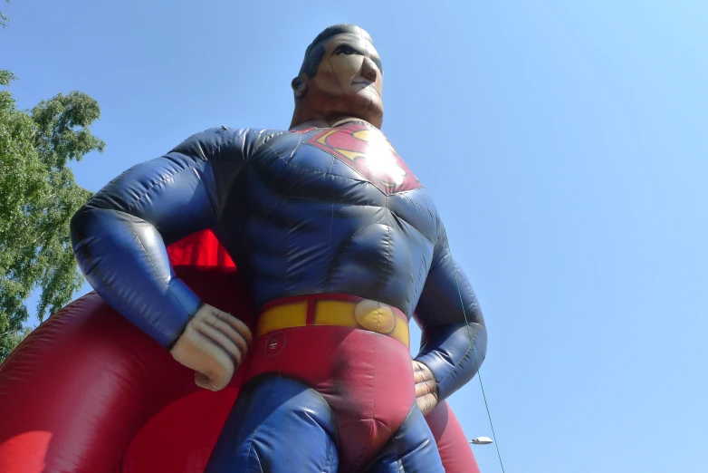 a man is dressed as a superman inflatable