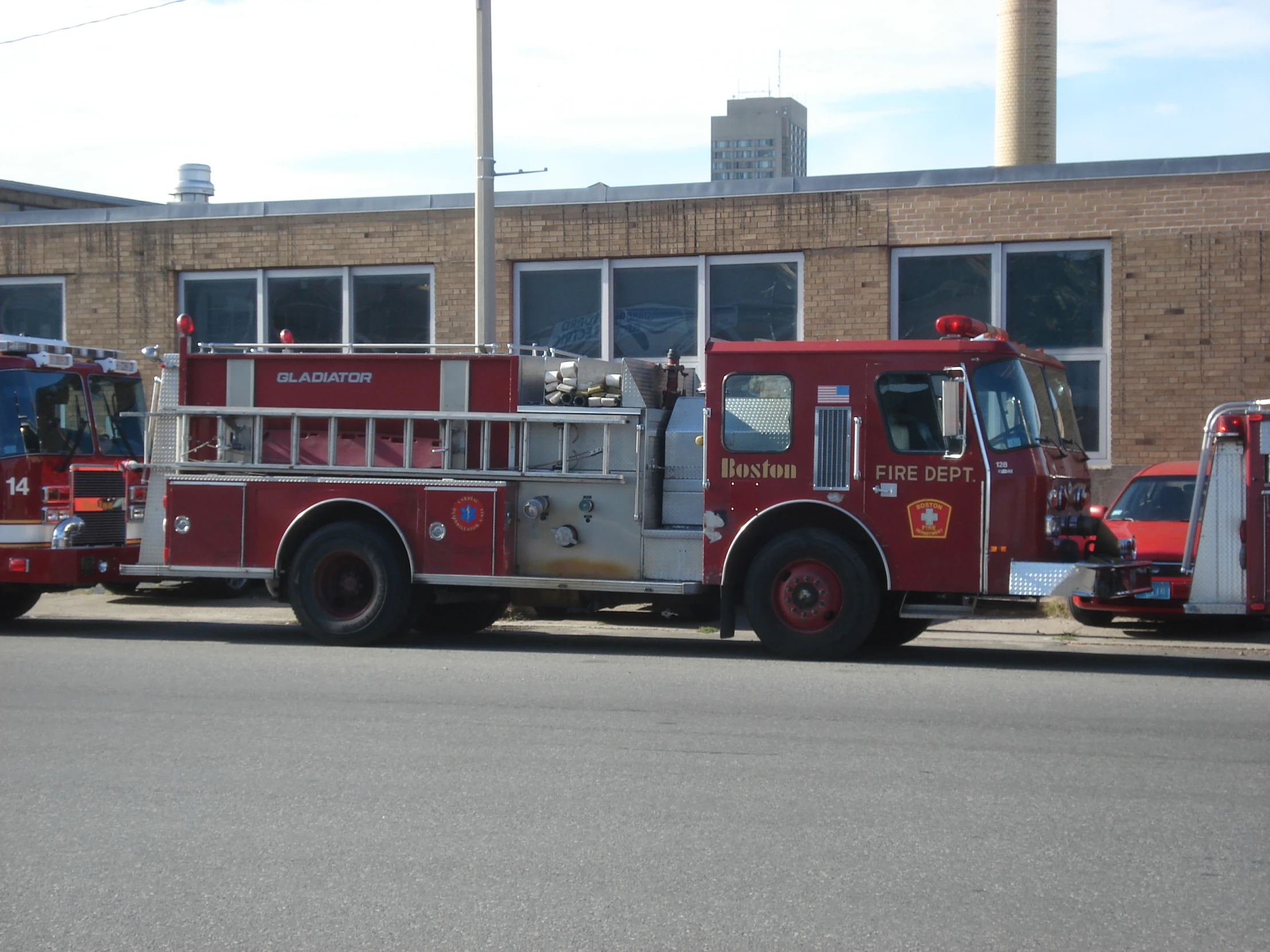 three fire trucks parked near one another in a lot