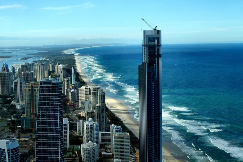 an airplane flying over a city next to the ocean