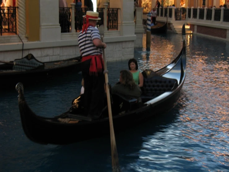 people riding a gondola in an upscale shopping district