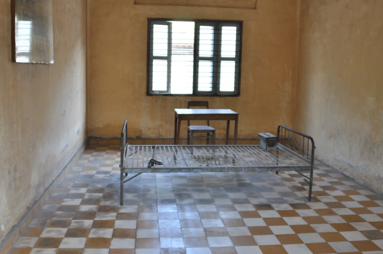 a small room with some stairs to an area with a window and a bed