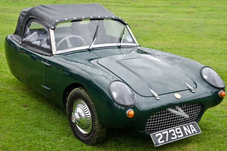 the old fashioned car is on display on the lawn