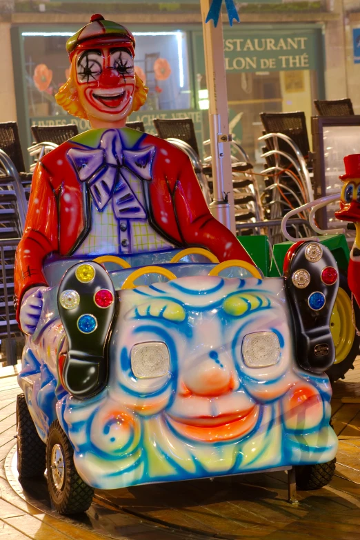 a clown's face painted on a toy car on display in a store