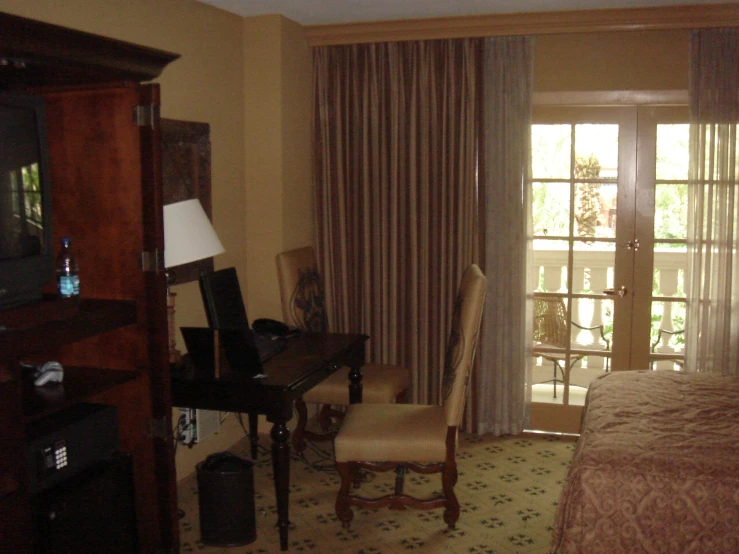 a el room with a balcony with a patio and door to the outside