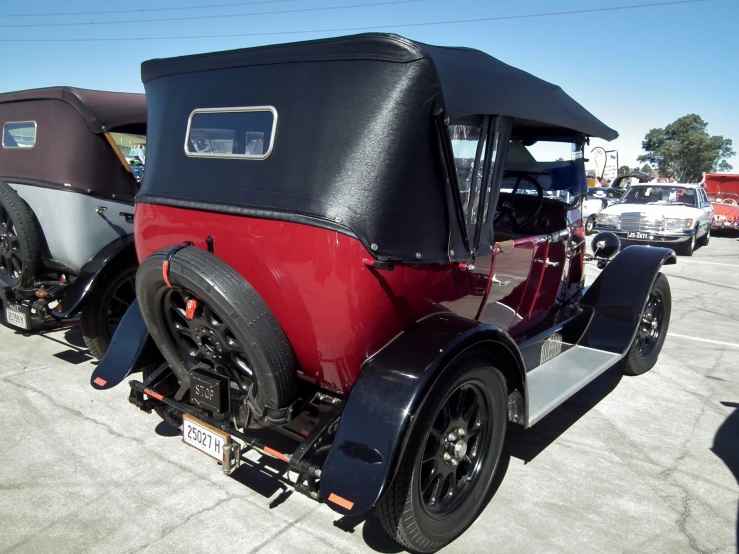 the old time car is parked in the parking lot