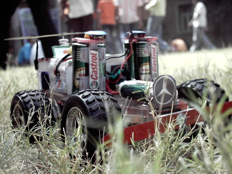 some cans are parked on a tractor in a field