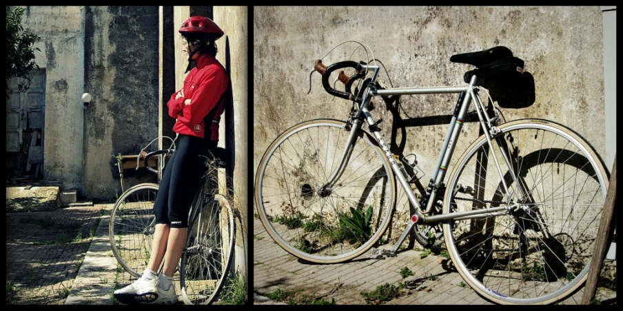 a woman with a bicycle standing next to a wall