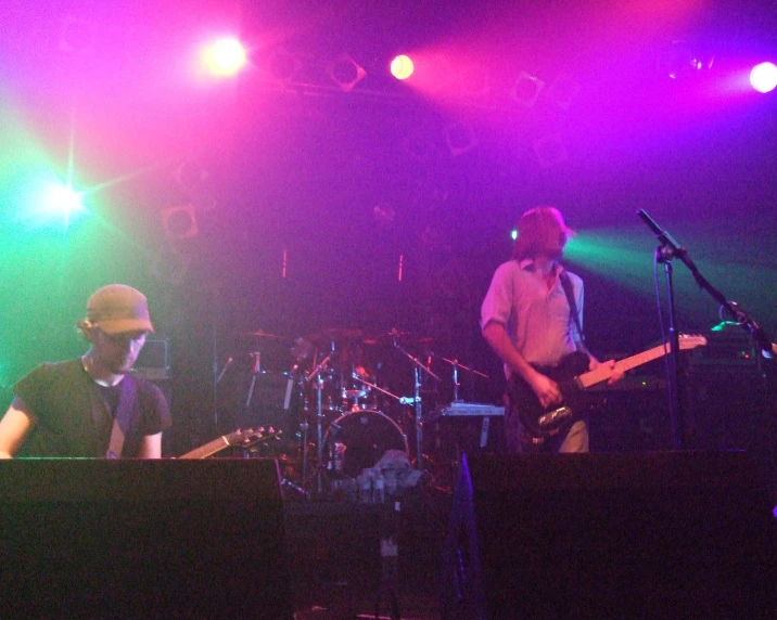 a band plays live music on stage with purple lighting