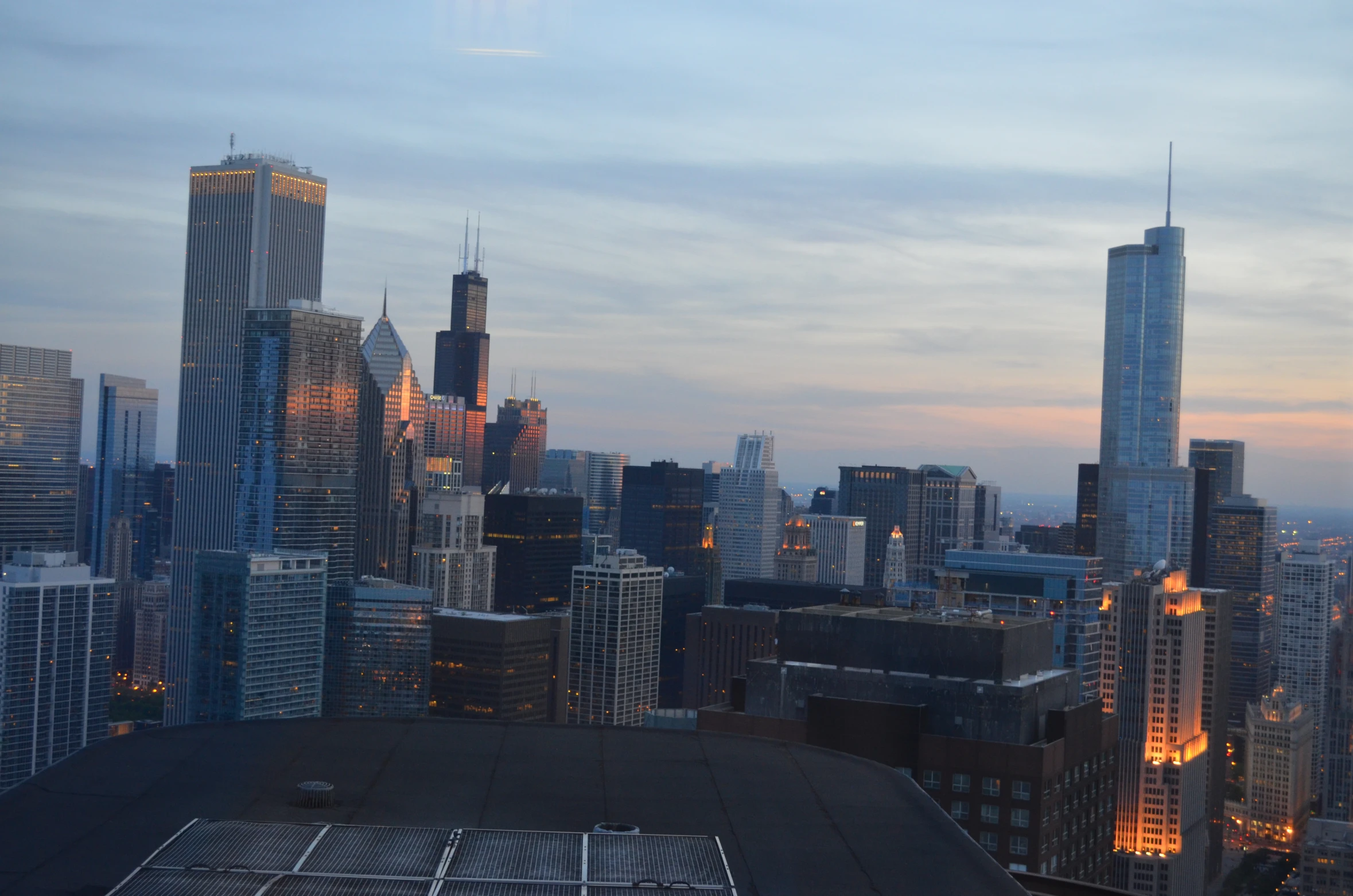 a city with buildings lit up at dusk