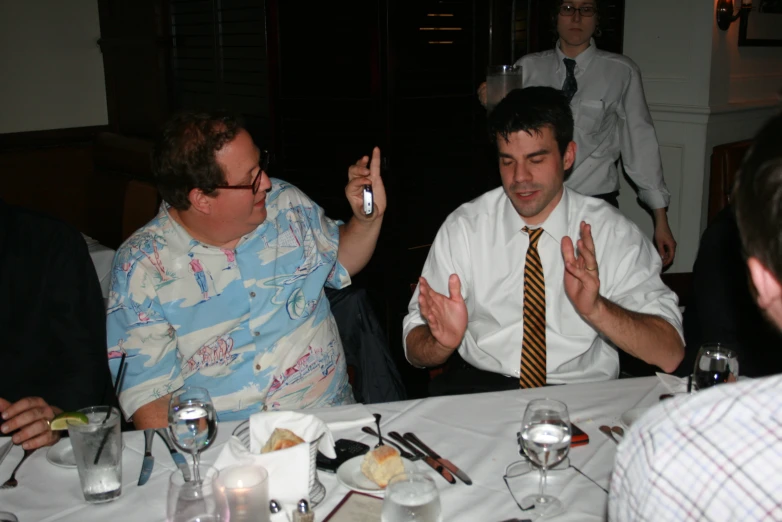 a group of men in business attire sitting at a table