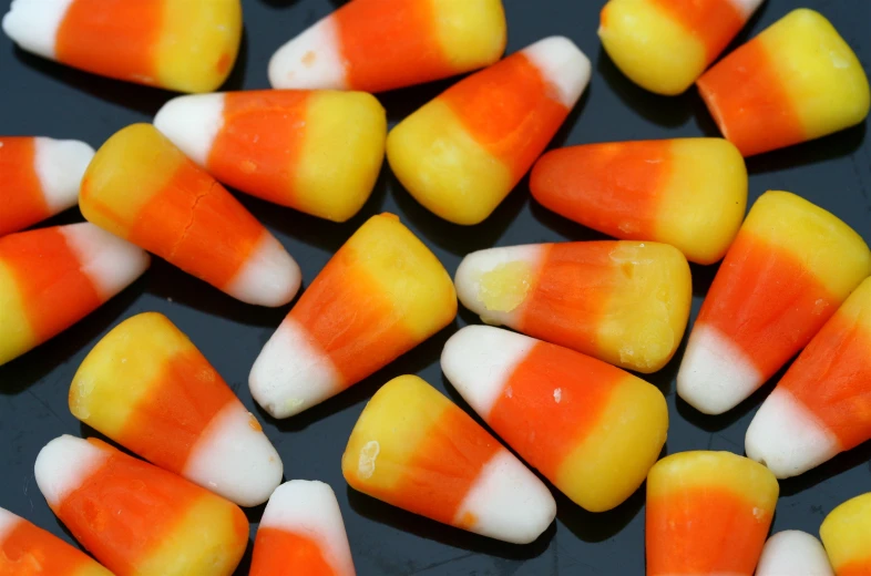 some yellow, white and orange candy is being displayed