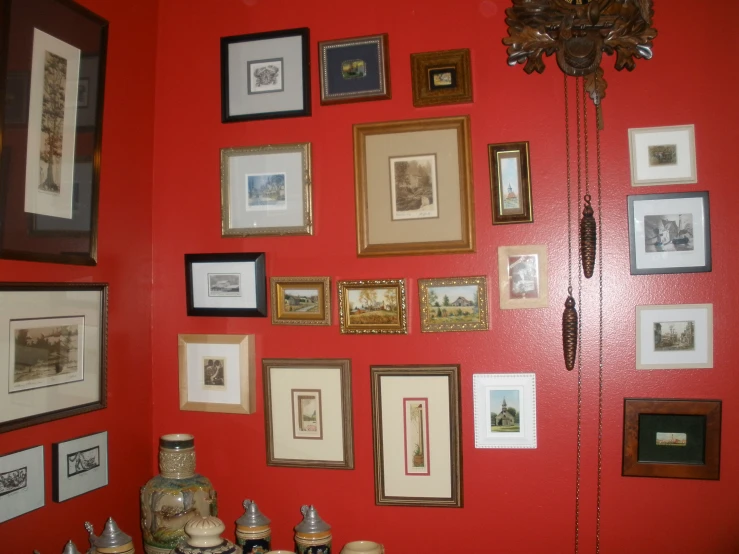 an all red room with many pictures hanging on the wall