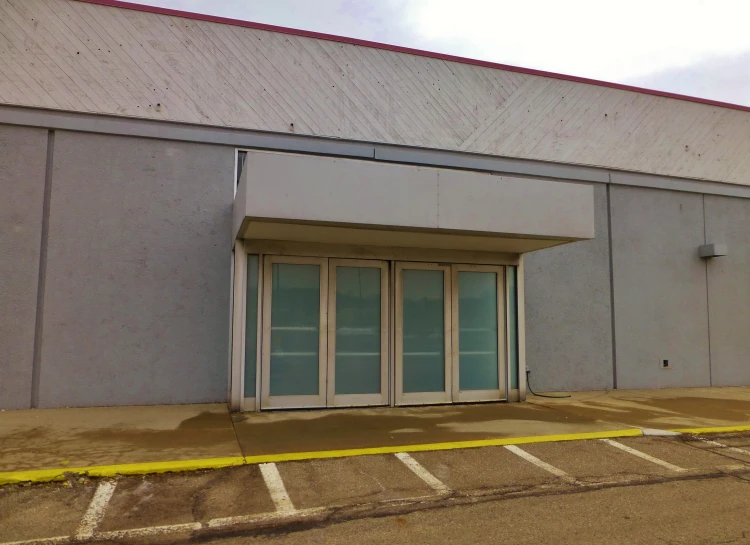 a empty parking lot in front of a closed building