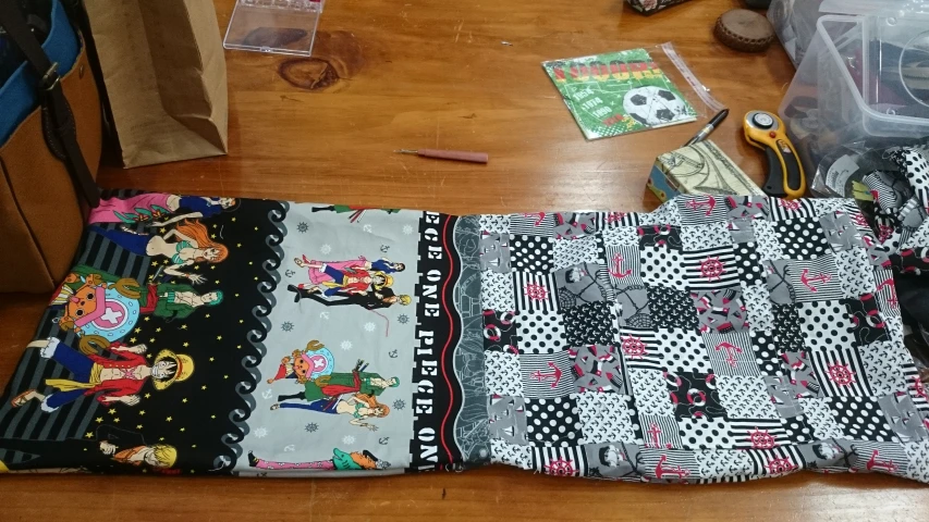 various quilts and sewing supplies on a wooden floor