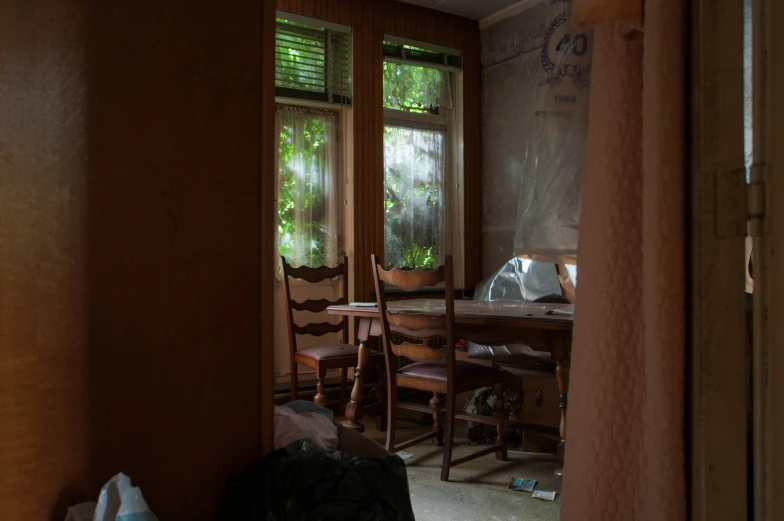 the dining room door is open, revealing the corner of the room with several pieces of furniture in it