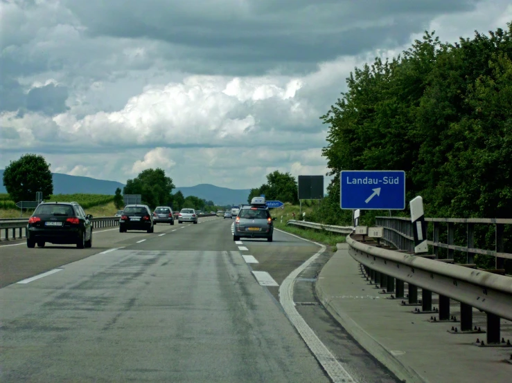 a blue sign that reads limit in the middle of traffic