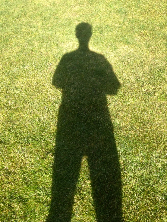 a shadow on the ground of a man