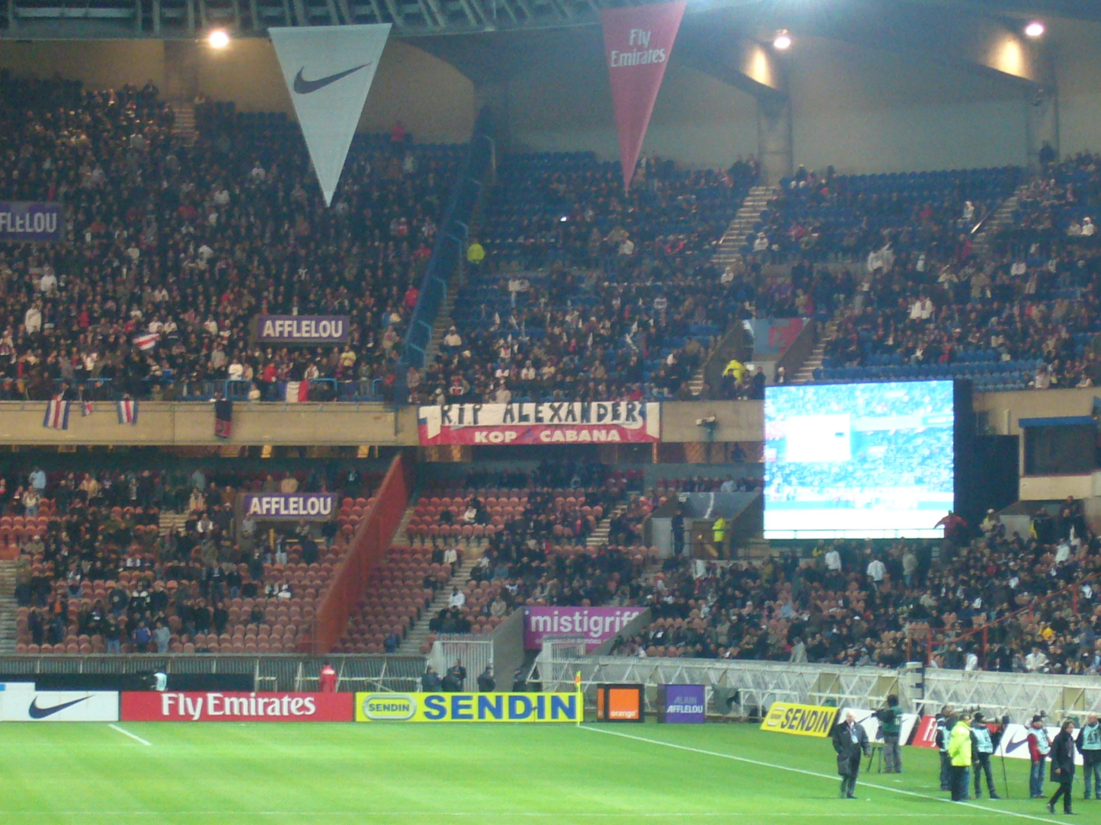 the people are standing around watching the soccer match