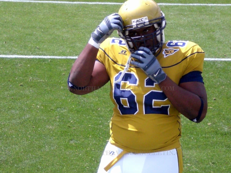 a young man standing on top of a football field