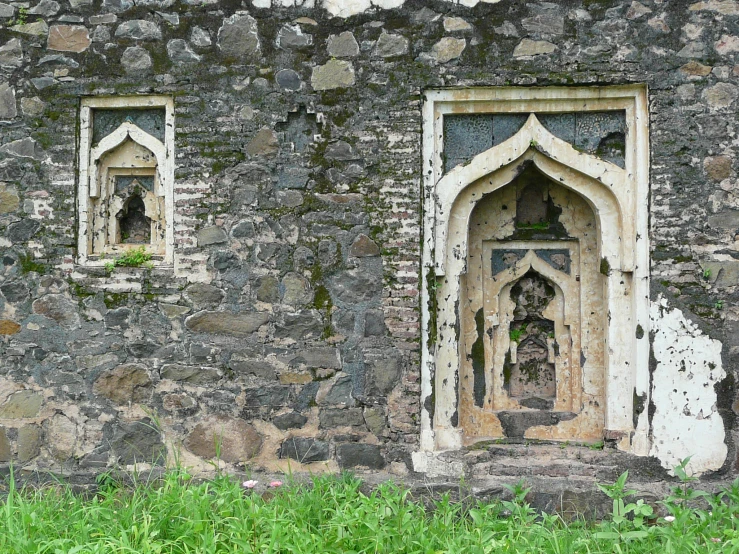 an old stone wall has two carved into it