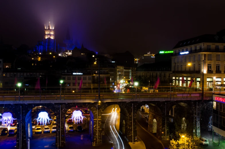 a city skyline with several buildings lit up at night