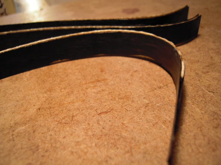 a black guitar strap sitting on a table