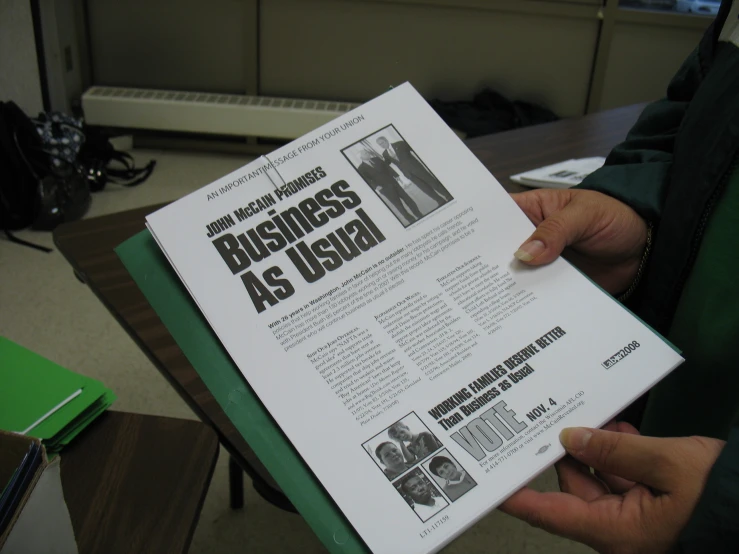 a person reading a business newspaper