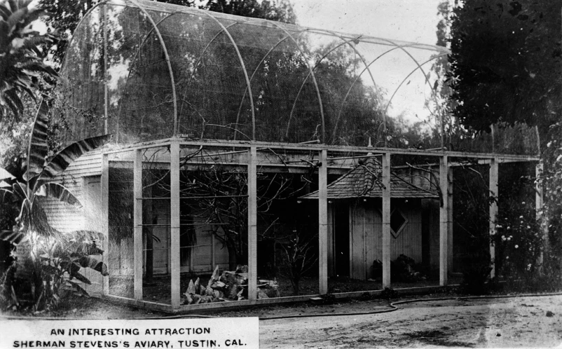 a building with a cage and people sitting inside of it